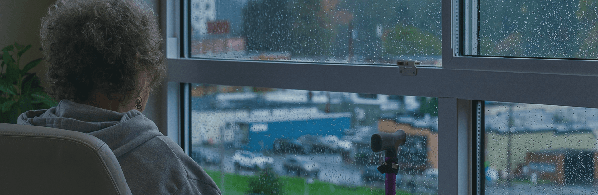 Senior man looking thoughtfully out of a window