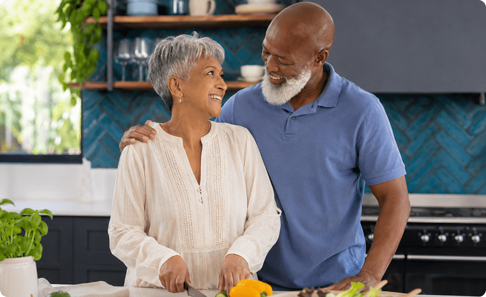 Older couple smiling while looking at a each other